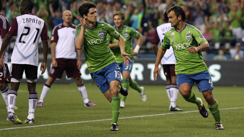 Seattle's Alvaro Fernandez celebrates a goal with teammate Patrick Ianni vs. Colorado
