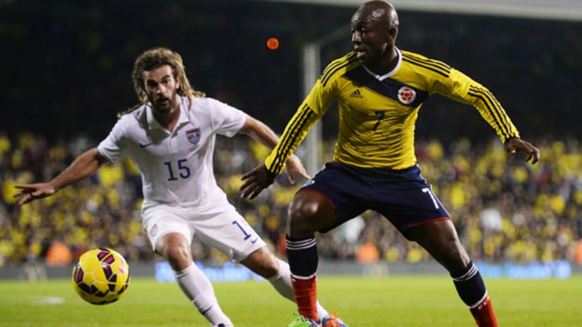 Kyle Beckerman defends for the USMNT against Colombia's Pablo Armero