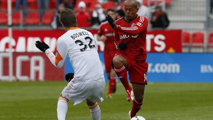 Toronto FC's Robert Earnshaw braces for a challenge from Houston Dynamo's Bobby Boswell