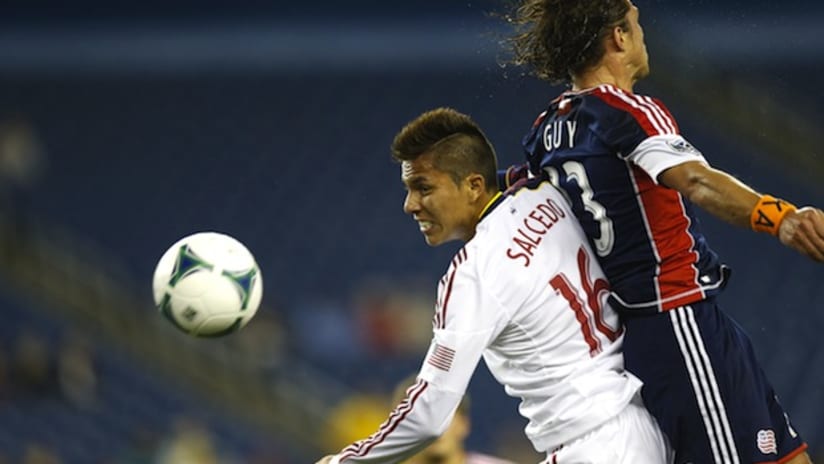 Carlos Salcedo and Ryan Guy contest a ball in the air