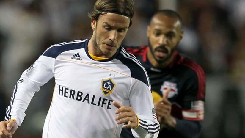 New York's Thierry Henry chases LA Galaxy's David Beckham (front).