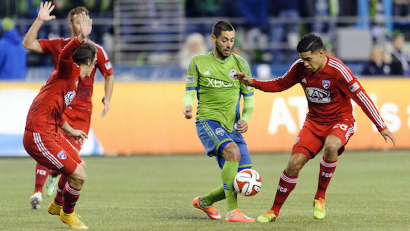 Clint Dempsey (Seattle Sounders) controls the ball in front of Victor Ulloa (FC Dallas)