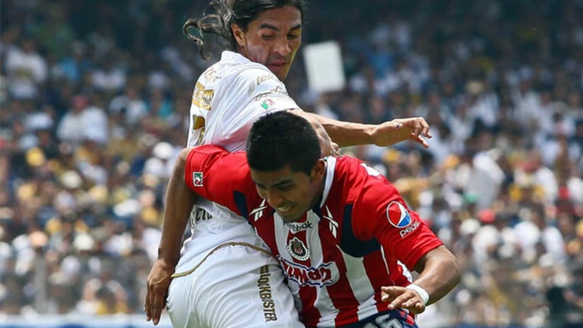 CD Chivas left back Miguel Angel Ponce (right) vies for the ball against Pumas UNAM's Francisco Palencia.