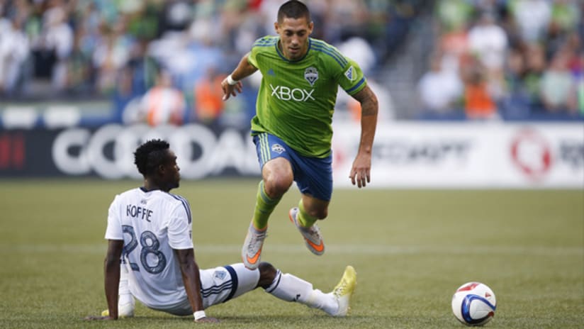 Clint Dempsey (Seattle Sounders) is tripped by Gershon Koffie (Vancouver Whitecaps)