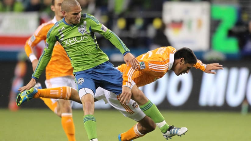 Ozzie Alonso outmuscles Brian Ching in Seattle's 2-0 win