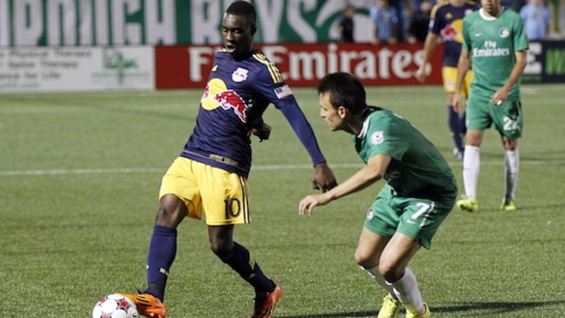 The New York Cosmos' Ayoze defends against the Red Bulls' Lloyd Sam