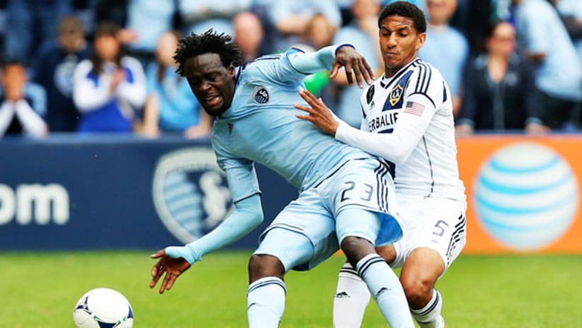 Sporting KC's Kei Kamara fights for the ball with LA Galaxy's Sean Franklin