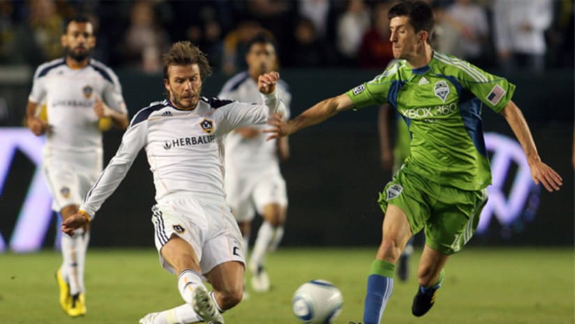 Seattle's Alvaro Fernandez (right) pressures LA's David Beckham in their playoff match on Sunday.