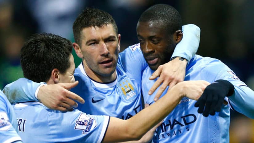 Manchester City's Samir Nasri, Eden Dzeko and Yaya Toure celebrate
