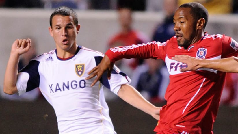 Chicago's Cory Gibbs (right) battles Real Salt Lake's Luis Gil (left) for control of a loose ball.