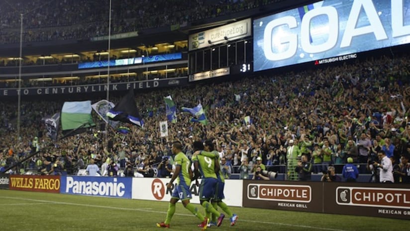Obafemi Martins, Mauro Rosales and DeAndre Yedlin celebrate in front of the Brougham End