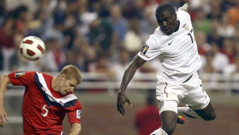 Jozy Altidore scores past Andre Hainault.