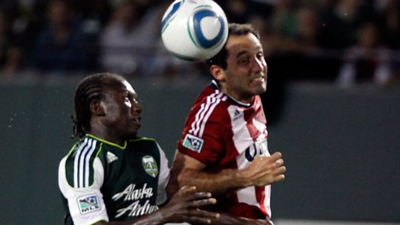 Nick LaBrocca contests a header with Diego Chara