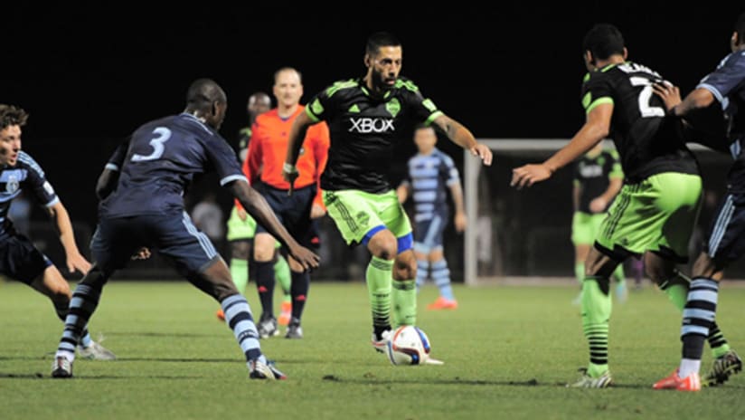 Clint Dempsey (Seattle Sounders) takes on the Sporting KC defense in preseason