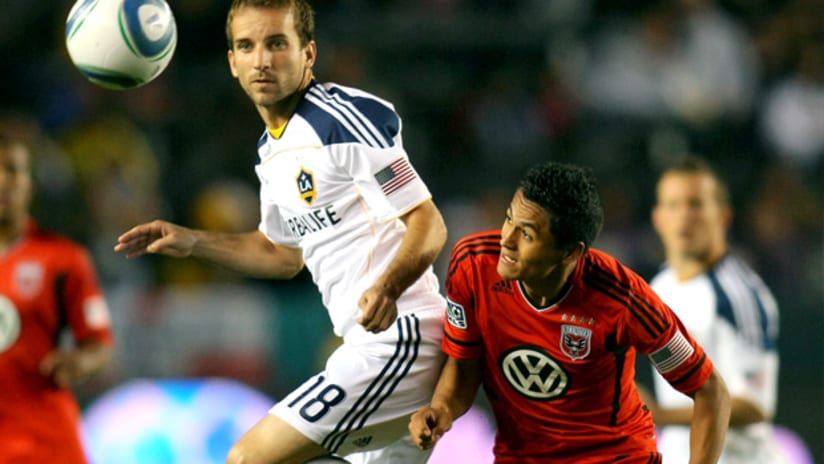 LA Galaxy's Mike Magee heads a ball away from D.C. United's Andy Najar during a 0-0 draw.