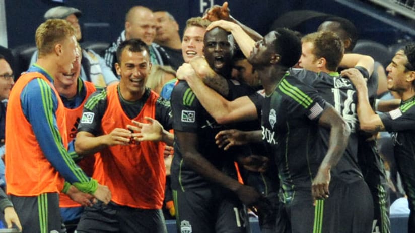 Seattle Sounders mob Djimi Traore after his game-winner