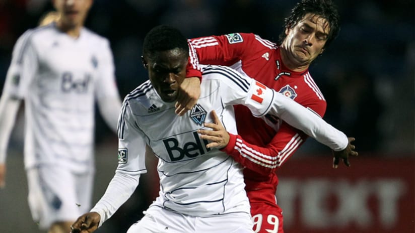 Vancouver's Gershon Koffie holds off Chicago's Diego Chaves.