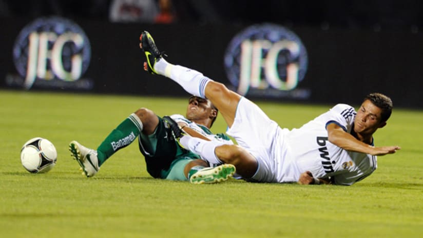 Real Madrid's Cristiano Ronaldo is tackled by Santos' Rodolfo Salinas in a WFC match