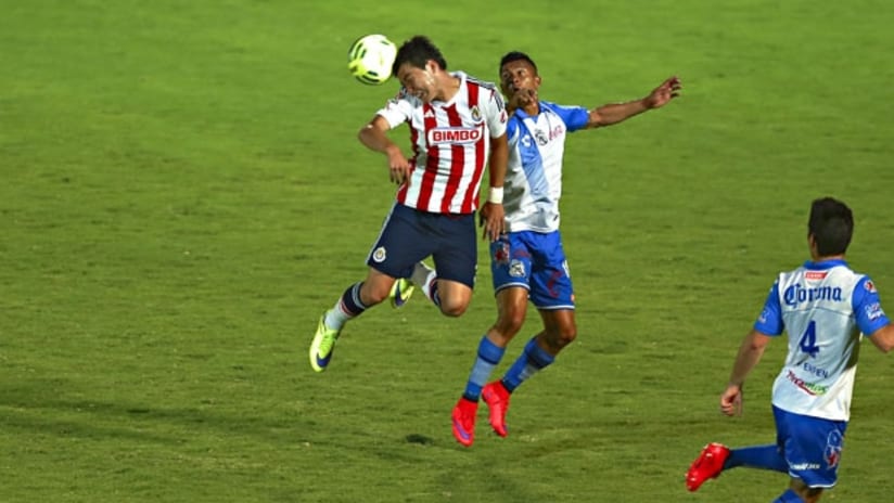 Puebla's Michael Orozco and Chivas Guadalajara's Erick 'Cubo' Torres battle for a header in the Copa MX final
