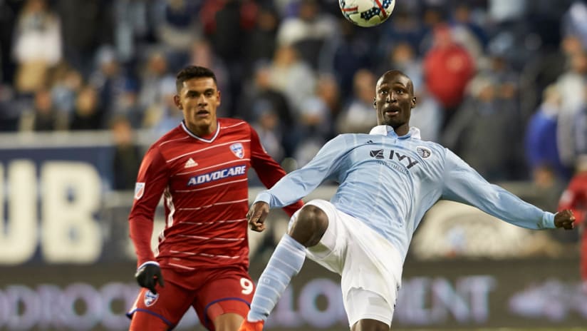 Ike Opara - Sporting KC - makes a play on the ball as Cristian Colman looks on