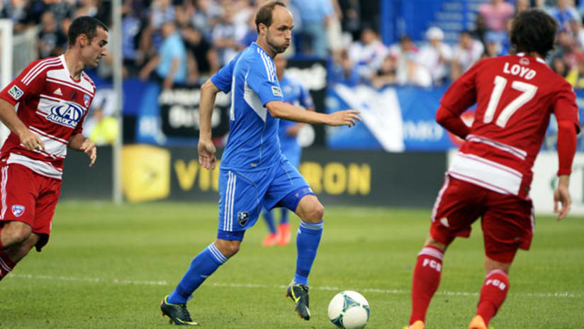 Justin Mapp, Montreal Impact, takes on two FC Dallas defenders.