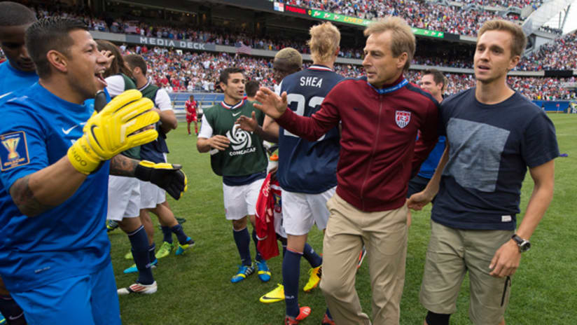 Jurgen Klinsmann celebrates with Stuart Holden and Nick Rimando after Gold Cup win