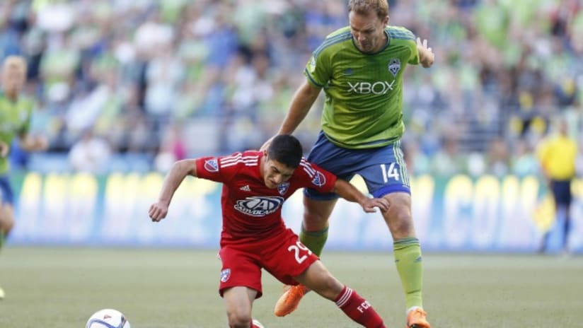 Seattle Sounders' Chad Marshall towers over FC Dallas youngster Alex Zendejas