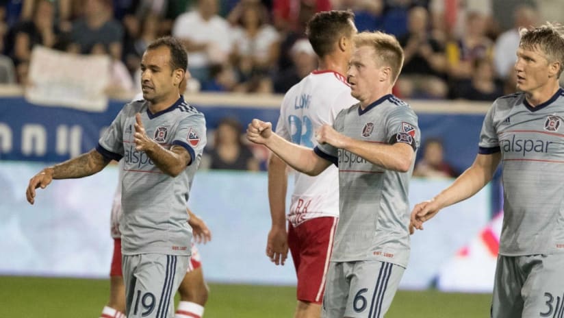 Dax McCarty, Bastian Schweinsteiger, Juninho - Chicago Fire - celebrate after McCarty's assist in his return to Red Bull Arena