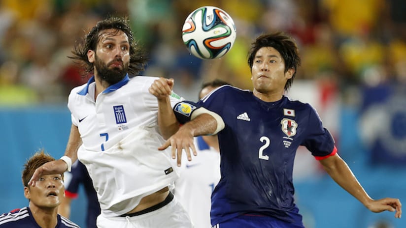 Greece's Georgios Samara and Japan's Atsuto Uchida in a World Cup game