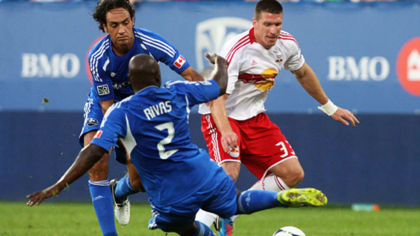 Montreal's Alessandro Nesta and Nelson Rivas collapse to tackle New York's Kenny Cooper.