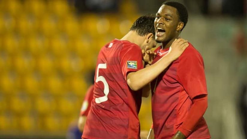 Cyle Larin and a teammate celebrate a goal for the Canadian U-20 national team
