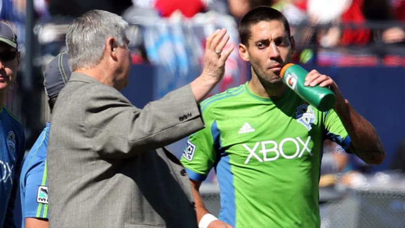 Seattle's Sigi Schmid gives pointers to a thirsty Clint Dempsey