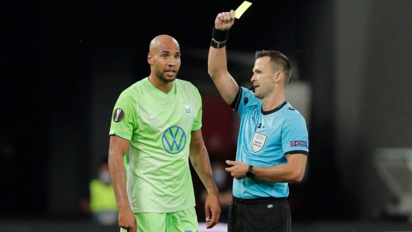 John Brooks - Wolfsburg - USMNT - shown a yellow card during Europa League play