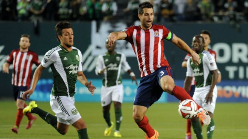 Chivas USA's Carlos Bocanegra clears ball vs. Portland Timbers