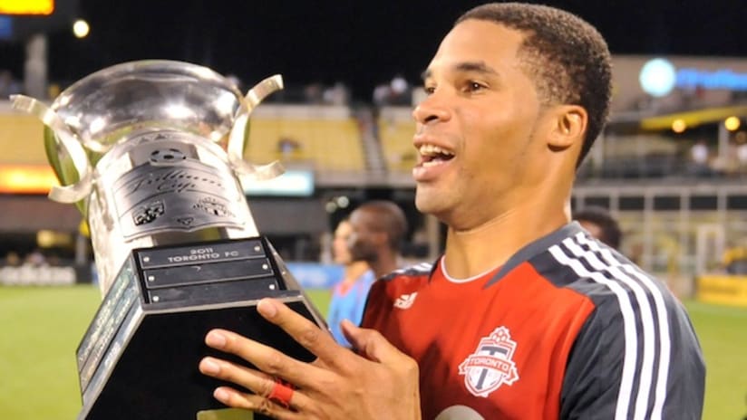 Toronto FC's Ryan Johnson celebrates with the Trillium Cup.