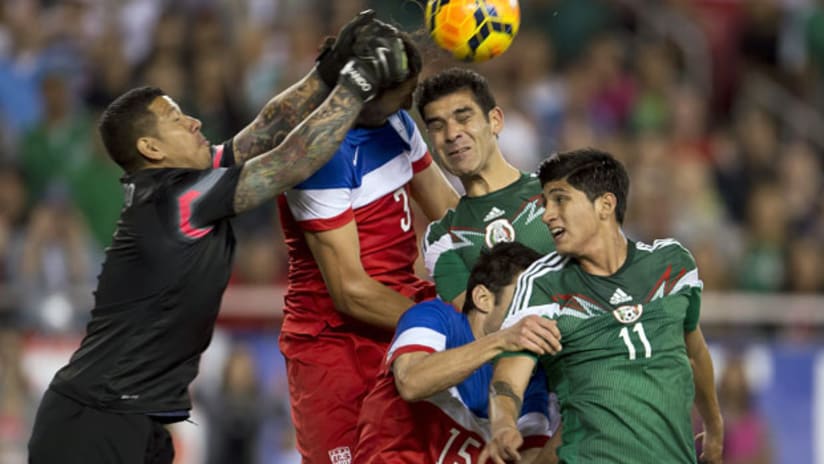 USMNT's Nick Rimando challenges a header from Mexico's Rafa Marquez in front of Omar Gonzalez, Alan Pulido and Tony Beltran