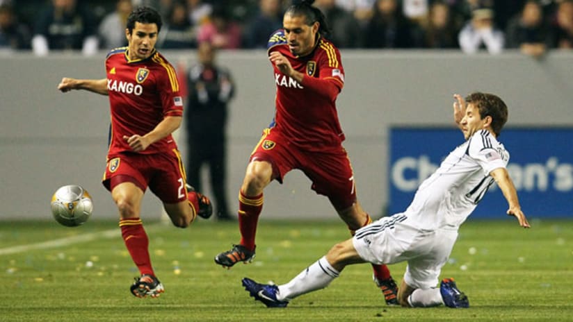 Real Salt Lake's Fabian Espindola avoids a tackle from LA's Mike Magee, March 10, 2012.