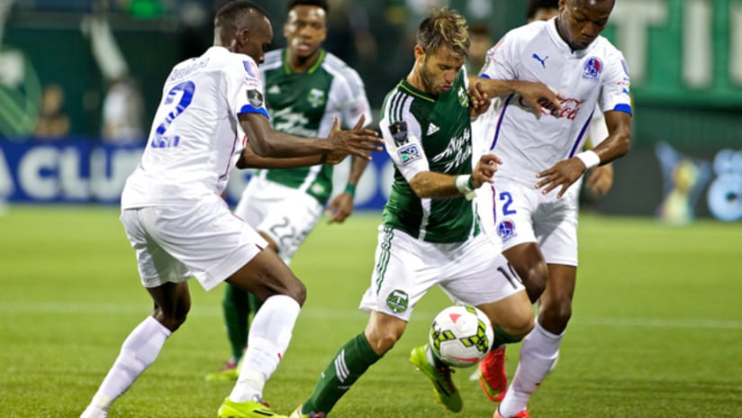 Gaston Fernandez (Portland Timbers) shields the ball from Olimpia players in CCL play