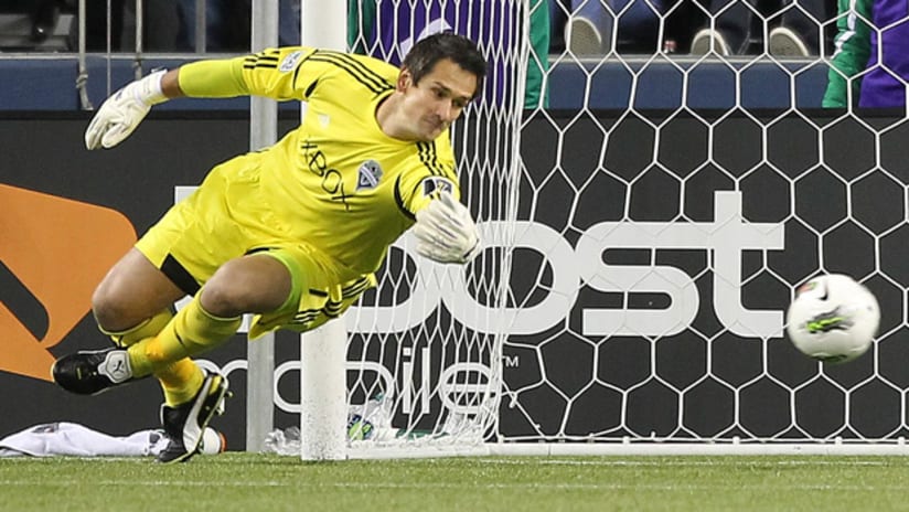 Seattle goalkeeper Michael Gspurning dives to save a shot in CCL game against Santos Laguna
