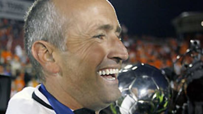 Houston's Dominic Kinnear holds the MLS Cup trophy for the first time as head coach.