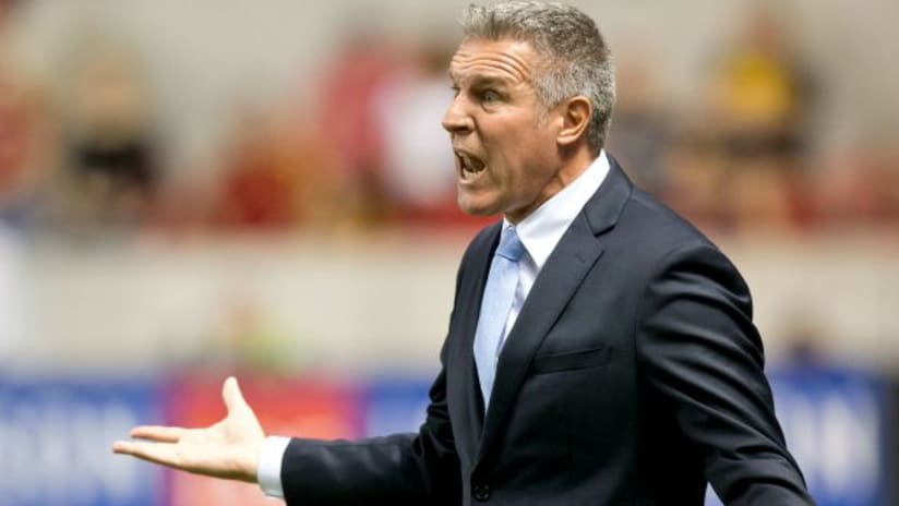 Peter Vermes (Sporting Kansas City) questions something during a game