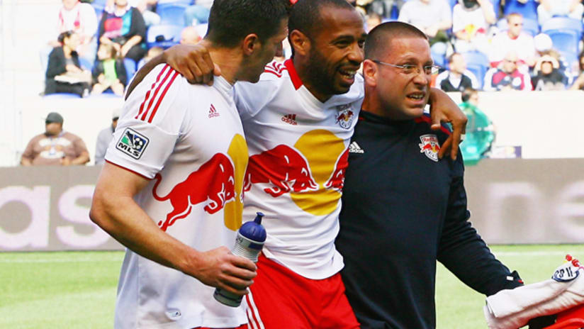 Thierry Henry is helped off the field after straining his hamstring