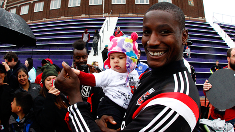Bill Hamid with a baby at Cardozo Open training