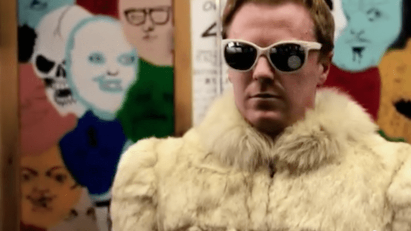 Dax McCarty wearing a fur coat and sunglasses