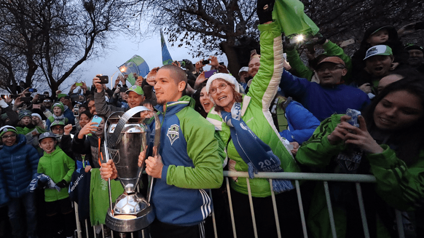 Osvaldo Alonso - Seattle Sounders - holds MLS Cup before crowd at airport - Dec. 11, 2016