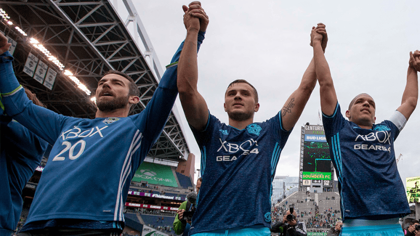Seattle Sounders - salute fans hand in hand at CenturyLink Field