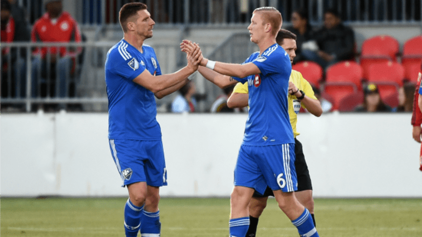 Kenny Cooper and Callum Mallace high five after a Montreal Impact goal