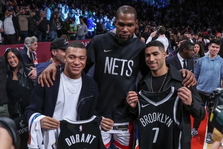 Paris Saint-Germain and French national forward Kylian Mbappe (left) and PSG teammate defender Achraf Hakimi (right) pose for a photo with Brooklyn Nets forward Kevin Durant