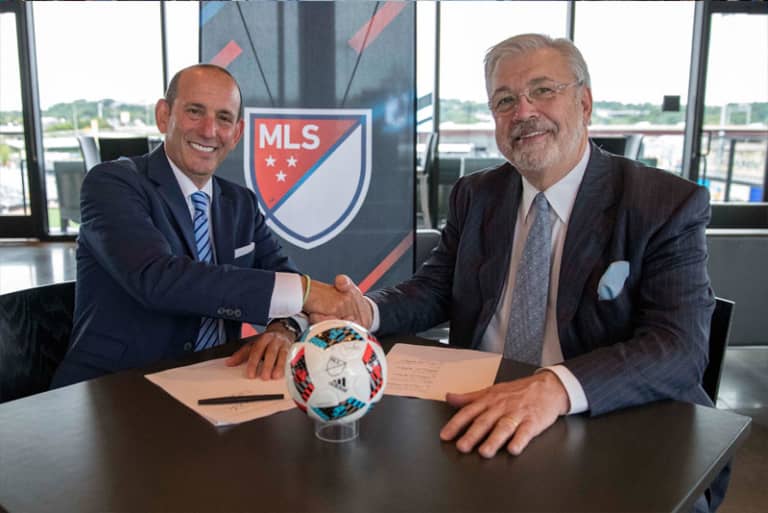 MLS made in Minnesota: Past, present & future of soccer in the Twin Cities - Dr. Bill McGuire and Commissioner Don Garber sign Minnesota's MLS contract.