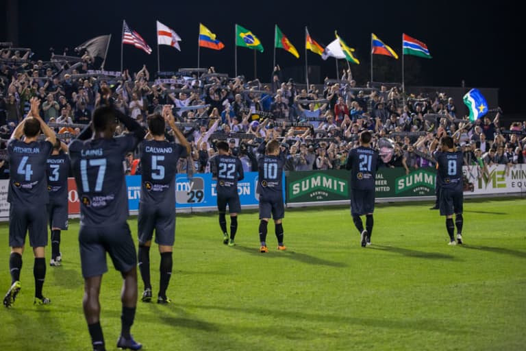 MLS made in Minnesota: Past, present & future of soccer in the Twin Cities - MNUFC players salute the supporter's after a win.